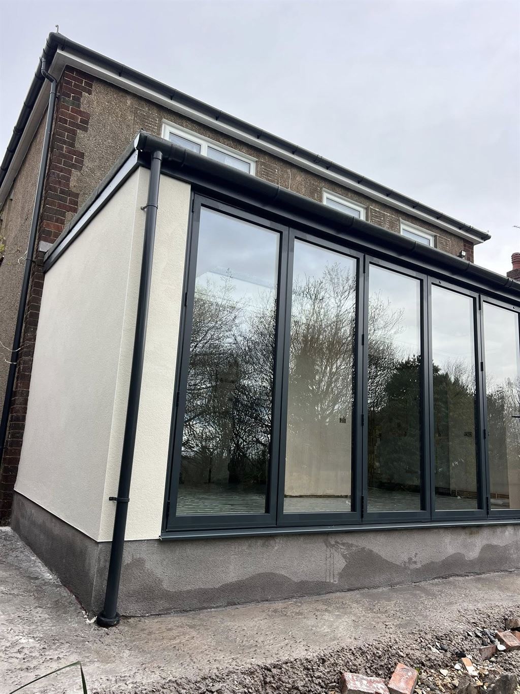 Modern orangery extension with full-height anthracite glazing