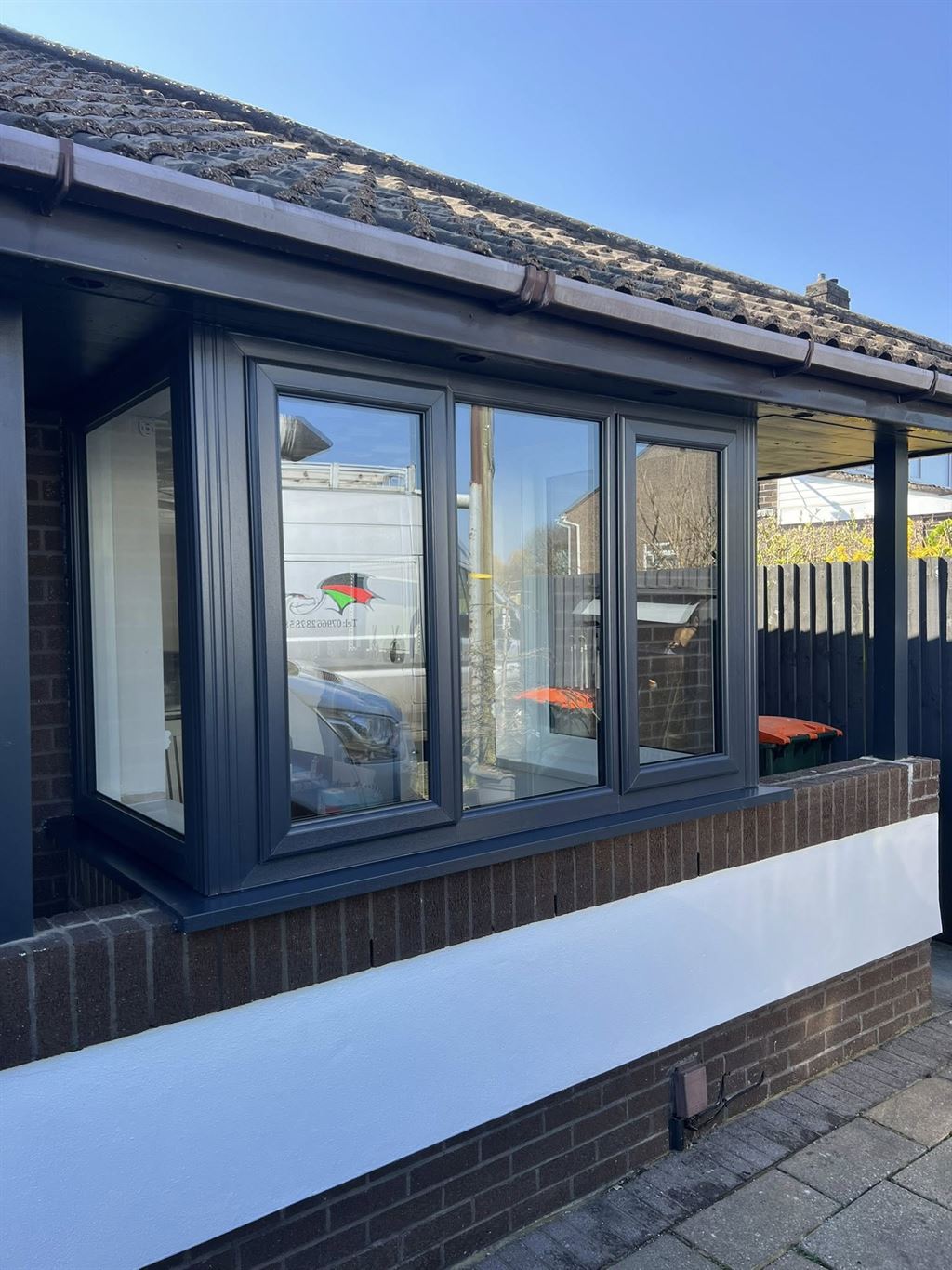 Anthracite grey uPVC bay window on a bungalow