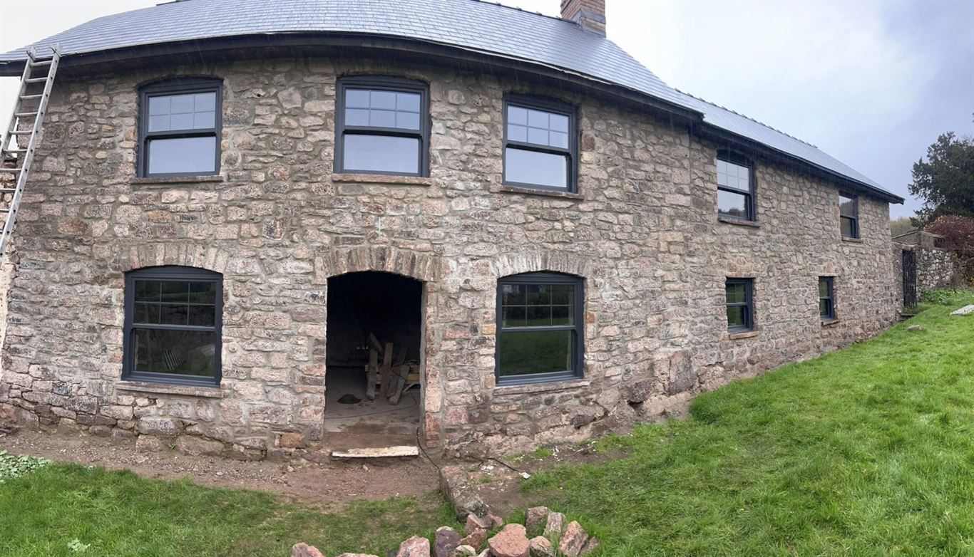 Anthracite uPVC windows fitted to a traditional stone cottage